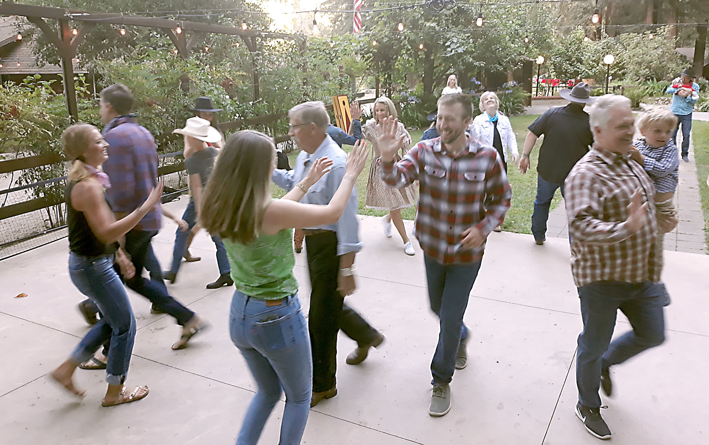 Family reunion barn dance with couples dancing in a community hall in Northern California