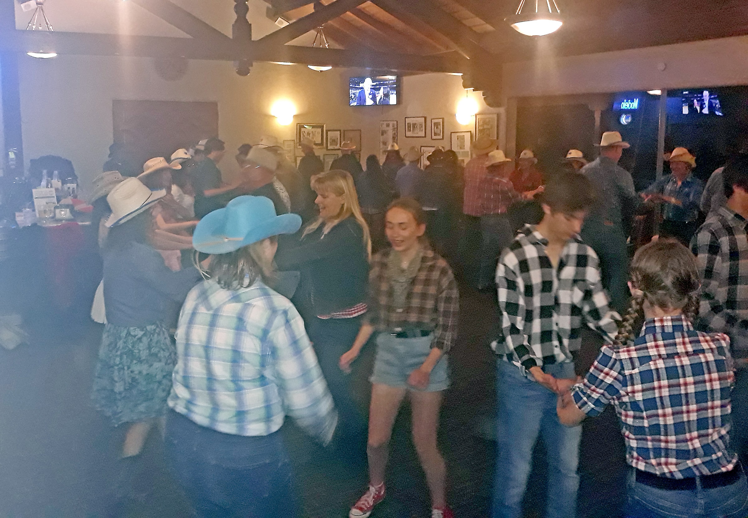 Students and parents dancing together at a barn dance event in Northern California