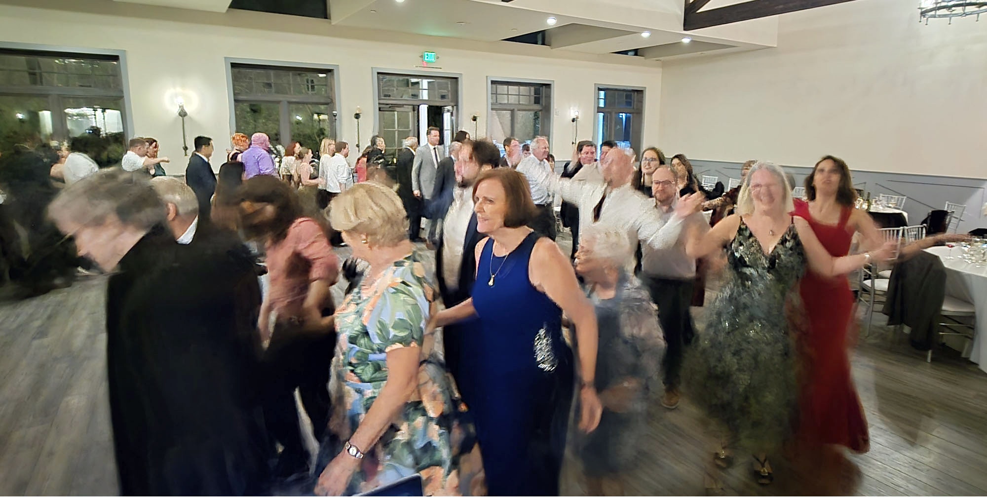 Elegant ballroom venue filled with wedding guests doing a barn dance segment in Northern California