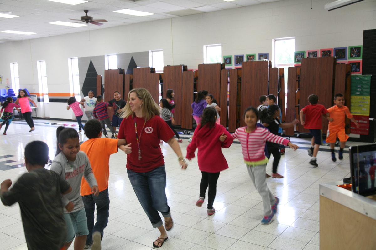 Dance leader with adults and couples at an indoor event