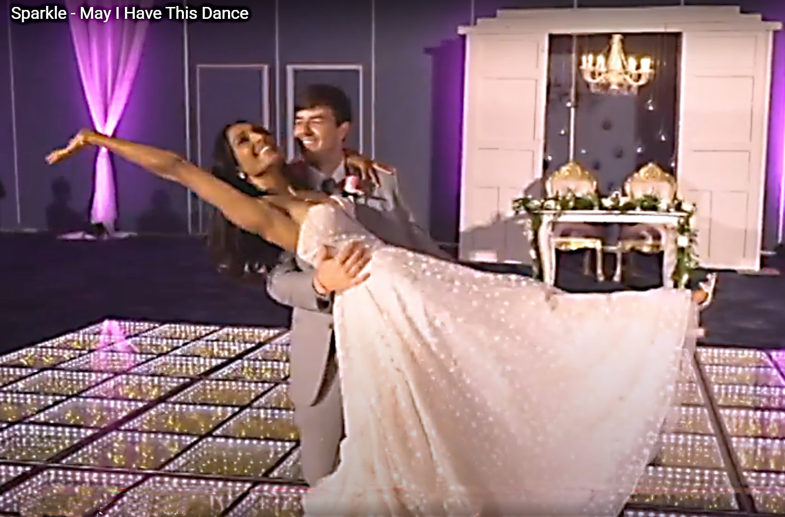 Wedding couple first dance choreographed to May I Have This Dance on a sparkling dance floor